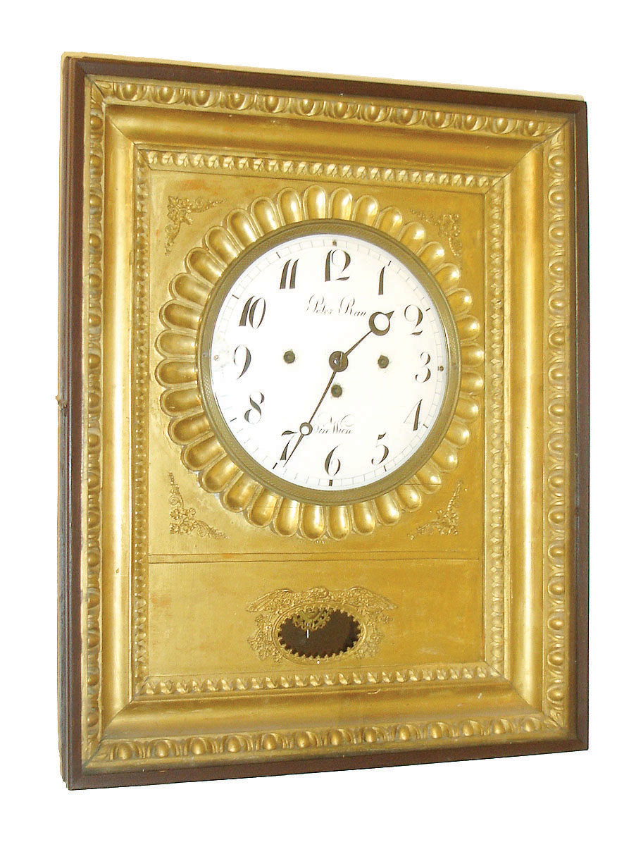 Peter Rau, in Wien, Austria, Rahmenuhr, or picture frame clock, gilt frame behind a glazed door, with carved moldings and applied ornament, signed Arabic numeral white enamel dial, steel moon hands, brass 2 day, three train grand sonnerie striking movement, gilt mask pendulum, c1820 — Antique Clocks Price Guide
