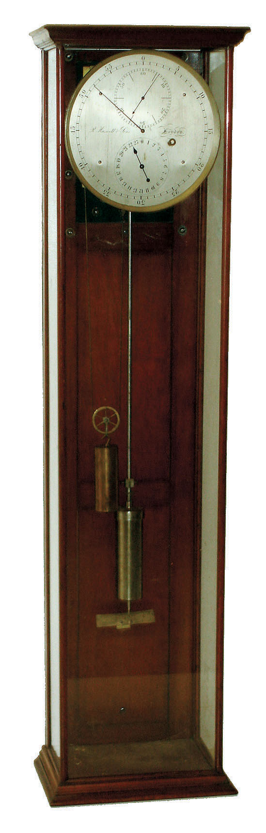 R. Haswell & Sons, London, England, astronomical  regulator, 8 days, time only, weight driven movement, the heavy brass 4 pillar movement  with break circuit mechanism designed to send pulses at one second intervals, Harrisons maintaining power, Graham deadbeat escapement with sapphire jeweled pallets, sapphire jeweled pallet arbor, escape wheel, and third wheel, all with endstones, the remaining mobiles with blued steel end pieces fusee type winding stop, crutch with fine beat adjustment, and compensated mercury pendulum, silvered astronomical dial, signed "R. Haswell & Sons, London, blued steel hands, and contained in a mahogany and glass display case with three glazed panels, the back now with added board with mounting brackets for the movement and pendulum, c1890 — Antique Clocks Price Guide