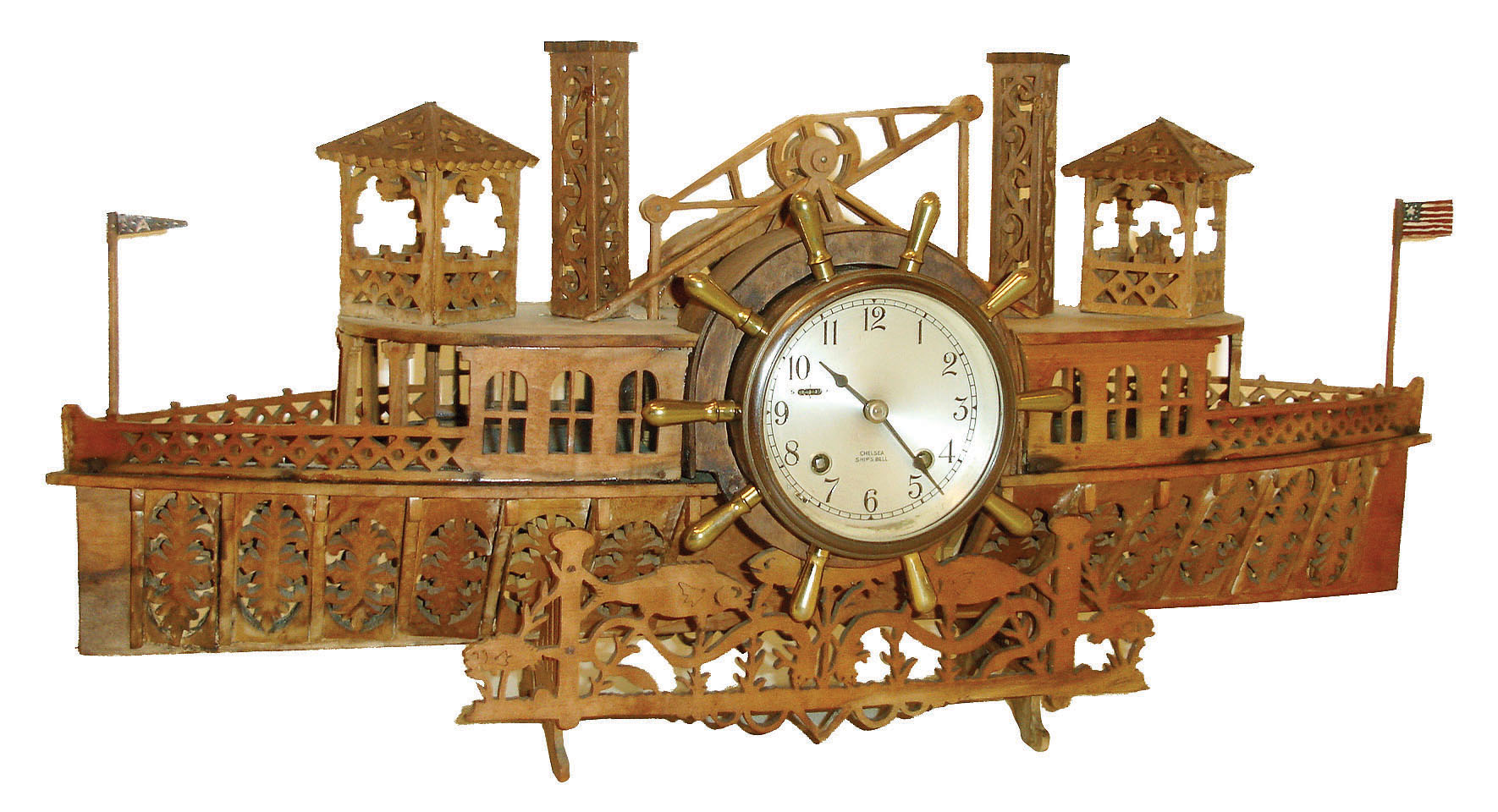 Chelsea Clock Co., Boston, Mass., ship's bell mantel clock set in an elaborate jig saw art case in form of a paddle wheel boat, c1920 — Antique Clocks Price Guide