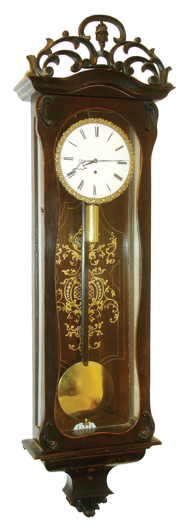 Austria, Vienna regulator, Biedermeier style, ebonized case with applied carved composition ornament, the removable, pierced crest with c scrolls and central mask, bottom bracket with gilt ornament, rosewood veneered backboard also with gilt ornament in the baroque style, Roman numeral white enamel dial with cast piecrust bezel, blued steel hands, 8 day timepiece movement, polished brass pendulum and weight, c1860 — Antique Clocks Price Guide