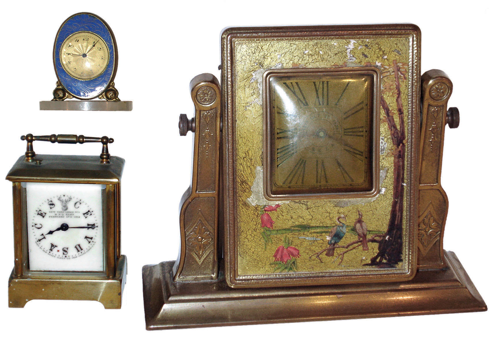 Clocks- 3 (Three) 30 hour desk: New Haven "Kenneth" carriage with Elks dial; "Claudine" Juvenia Swiss miniature enamel with white marble base; "CBKZA" easel-form gold painted Asian theme; early 20th century — Antique Clocks Price Guide