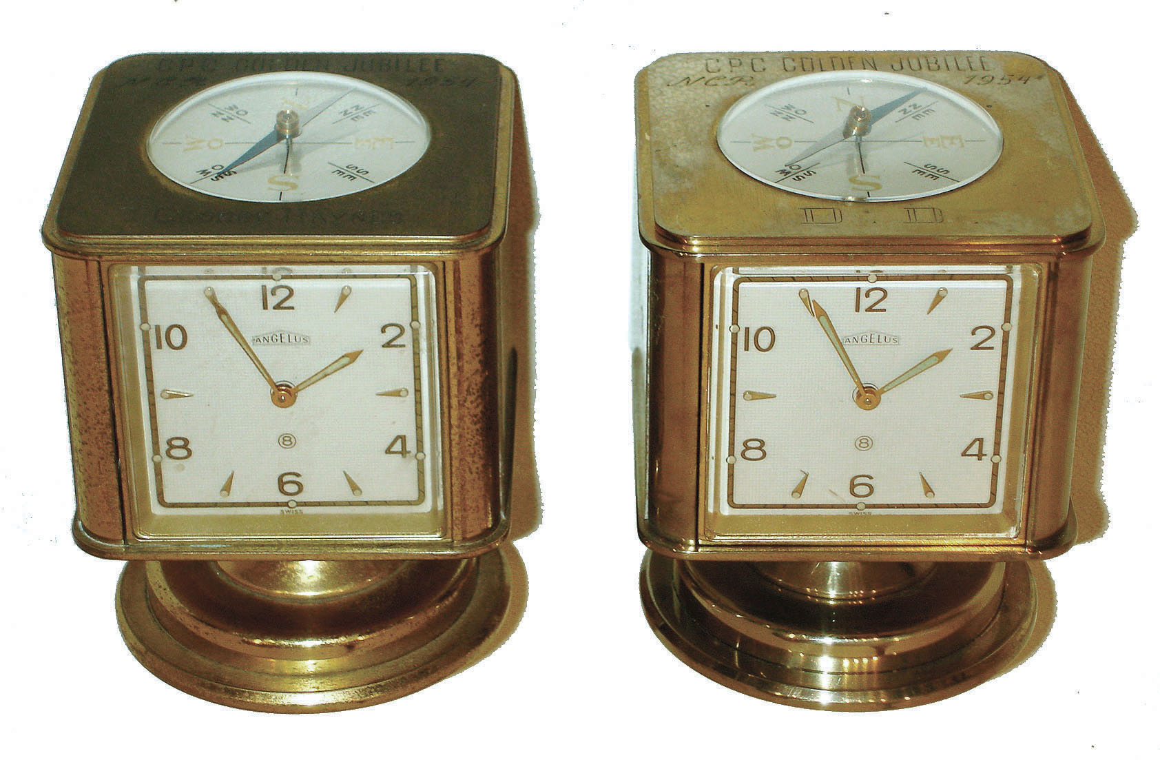 Clocks- 2 (Two): Angelus, Swiss-made swiveling weather stations 8 day timepieces in brass cases with barometers, Celsius & Fahrenheit thermometers, hygrometers and top compasses. Both have "CPC Golden Jubilee NCR 1954" on top. — Antique Clocks Price Guide