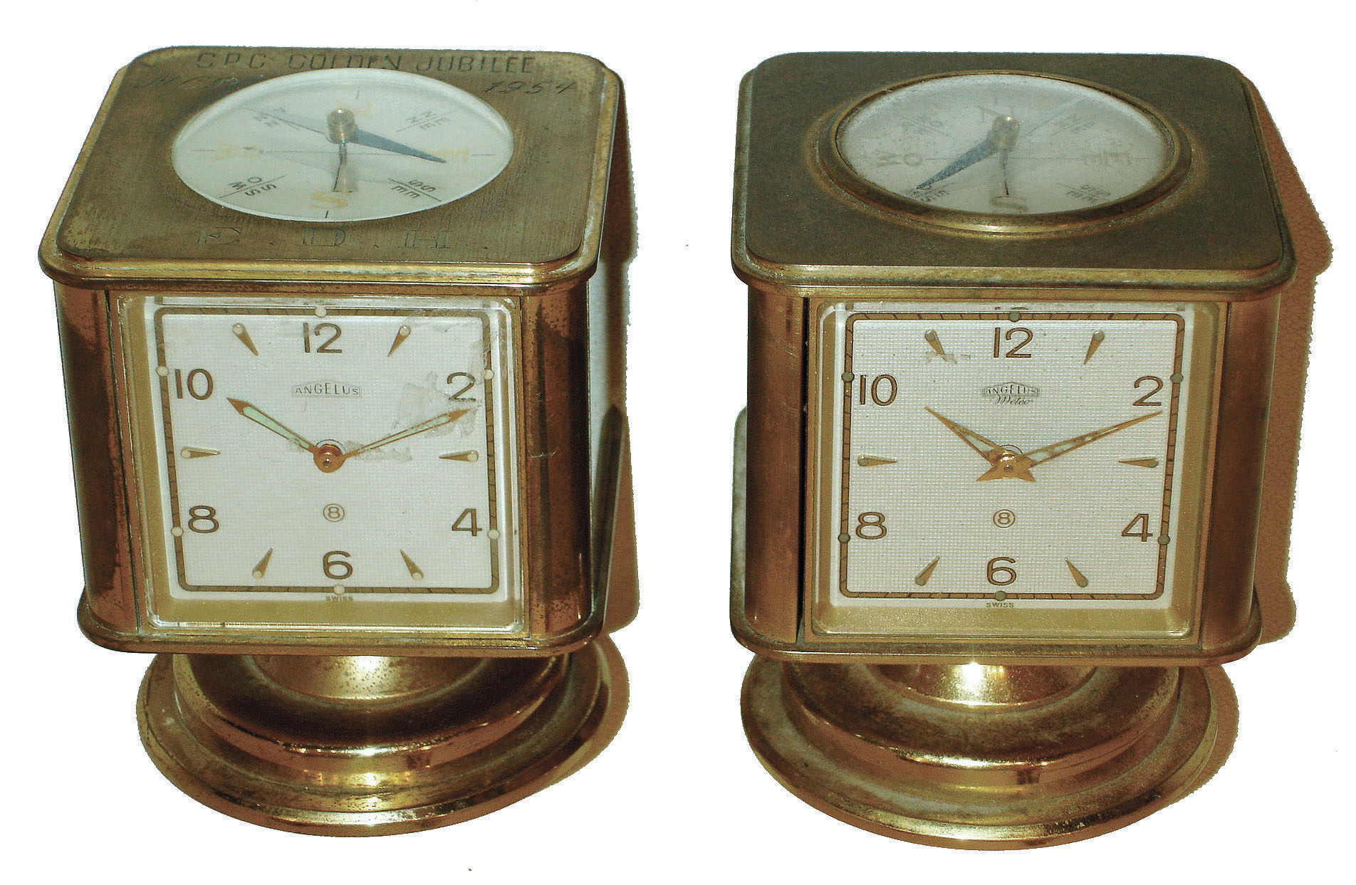 Clocks- 2 (Two): Angelus, Swiss swiveling weather stations in brass cases, 8 day timepieces with barometers, Celsius & Fahrenheit thermometers, hygrometers and top compasses. One has "CPC Golden Jubilee NCR 1954" on top. — Antique Clocks Price Guide