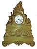 Taveau Freres a Paris, France, gilt bronze figural mantel clock, base and mid section of case with renaissance revival style ornament consisting of scrolls, trailing vines, and leaves, the upper section with female figure and two children, one at prayer and with cross, the left with foliate ornament and with books at the right, Roman numeral white enamel dial signed "Taveau Freres a Paris", gilt hands, 8 days, time and strike, pendule a Paris movement with silk thread suspension, marked "Pons" and "Taveau Freres c1850