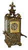 Desk or table clock, French 8 days, time and strike, movement with hour repeating, Roman numeral silvered dial with engraved, gilt mask, blued steel fleur de lis hands, the case with lis glasses and in the form of a sedan chair, the cast case decorated with faux repousse ornament in the rococo style and with fleur de lis finial, and with removable carrying handles, c1890