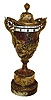 France, orbital or rotary dial clock, in the shape of a large urn, and with a red variegated marble case, the urn, base and cap all cut from the matching stone decorated with bronze trimmings, and with the time indicated via two rotating dials, one for minutes and one for hours, and with a jeweled serpent on the front of the urn, pointing to the current time, c1880