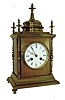 France, a polished brass desk clock of architectural form, with 4 free standing columns at the corners, a temple top and 5 finials, and an 8 days,bell strike movement, c1890