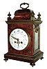 France, small bracket clock with red shell veneer, classis bell top case with ormolu accents, the base with round cast feet, and the porcelain dial with polychrome floral accents and embossed hands in the Louis XVI style, and the movement signed L Marti & Cie, and with award medallion for1889, c1890