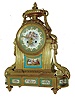 France, exceptional ormolu mantel clock in the Louis XVI style, featuring floral, gilt edged porcelain panels in the base, two ladies and a gent in the park below dial, and and the porcelain panel dial with winged cherubs in the clouds, and with good pendule a Paris movement, the case with profuse ormolu trimmings -- acanthus swags and ribbons, surmounted by an oval urn, c1840