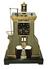 Guilmet, France, industrial series "Steam Hammer", polished and patinated bronze case on a black slate base with polished feet, the hammer forming part of the complex compound pendulum, rising and falling, appearing to strike the anvil as the clock runs, 8 days, time and strike, pendule a Paris movement signed Japy Freres with Guilmets modifications, and also with Guilmet's mark on the back plate, c1880