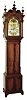 Herschede Clock Co., Cincinnati, Ohio, custom 9 tube hall clock, 8 day time, strike & chime, three weight driven movement playing three tunes, Westminster, Wittington, Canterbury in a mahogany case with fluted Corinthian quarter columns on trunk and base, bracket feet, crotch mahogany panels on door and base, carved relief work on arch above dial and above door and full fluted columns with brass Corinthian tops and bases. The broken arch top has carved floral rosettes, dental molding and fine cup finials. The silvered engraved dial has wax filled Roman numerals on an applied chapter ring and moon phase, c1921