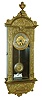 Rudolf Mayer, Germany, miniature Vienna style 8 days, timepiece, cast brass ornamental front attached to a wooden case with enamel beat scale, arch top with finial, back of top signed "Rud. Mayer Fec" and with his trade mark, glazed door with arched aperture, Roman numeral silvered dial with embossed, ornamented gilt center, the pendulum with matching embossed decoration, blued steel hands, brass timepiece movement with dead beat escapement, c1900