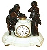France, 8 days, time and strike, figural mantel clock with pendule a Paris movement, deeply molded white marble base on gilt feet supporting a fluted marble cylinder containing the clock dial and movement, with flanking patinated figures, each with musical instruments, the figure on the left cradling a nest with two birds, gilt bezel with thick beveled glass, Roman numeral white enamel dial, blued steel Breguet style hands, c1870