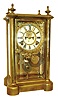 Ansonia Clock Co., Brooklyn, NY. "Symbol Extra" crystal regulator, polished brass case, Roman numeral white enamel dial with open escapement and fancy cast bezel and surround, gilt Louis XV style hands, 8 days, time and strike, movement, gilt cameo style pendulum, c1900