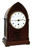 Vigne & Lautier, Bath, England, small bracket clock, lance arch mahogany and mahogany veneer case, with inlaid brass moldings, brass columns and trim, and thin brass feet, the sides with fabric lined pierced brass frets, the back with glazed door, Roman numeral white enamel convex dial, pierced arrow hands, signed brass 8 day fusee timepiece, the shouldered back plate with engraved border, c1835