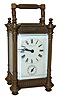 France, for Ritchie & Son, Edinburgh, Scotland, 8 day carriage timepiece with alarm, the bell concealed in the base, gilt brass case with turret corners and turned finials, and with pierced Gothic fret, Arabic numeral white enamel dial, blued steel hands, and with leather covered travel case, c1890