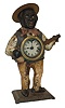 Waterbury Clock Co., "Sambo" blinking eye novelty clock, the figure in brightly colored clothing and playing a banjo, with clock mounted in his belly, Roman numeral painted dial, 30 hour lever timepiece, with linkage to escapement for blinking eyes, all on a molded cast iron base, c1860