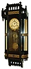 Ansonia Clock Co., New York, "Reflector" model 8 day spring driven time and strike (cathedral gong) hanging wall clock in an ebony finished case.
