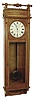 Self Winding Clock Co., New York, "Regulator No. 13" wall clock, time only, electric wound movement with meter long pendulum in an oak carved oak with fan carvings and spindle top and painted metal dial, c1887