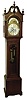 Evans, Birmingham, England, tall clock, 8 days, time and bell and gong strike, brass weight driven movement in a mahogany case with broken arch top, carving above beveled trunk door and brass dial with engraved silver chapter ring, date calendar and moon phase c1900