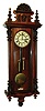 Gustav Becker, Freiburg, Germany, Vienna regulator, walnut veneered case with finials, removable crest with composition mask and scallop shell, Roman numeral white enamel dial with small seconds below 12:00, pierced blued steel hands, brass 8 day weight driven time and strike movement, brass weights, c1900