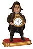 Bradley & Hubbard, Meriden, Conn., Continental blinking eye shelf clock, painted iron case with clock mounted in figures belly, Roman numeral white enamel dial, now mounted to a gilt wooden base, c1860