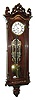 Austria, miniature Vienna regulator, rosewood veneered case with brass and pewter inlays in bottom bracket and backboard, door with acanthus carving at bottom, and with full length sentinels at top, with removable, rococo style scroll carved crest, and leaf and scroll carved finials, Roman numeral white enamel dial, blued steel hands 8 day brass timepiece movement, polished brass pendulum and brass weights, c1860