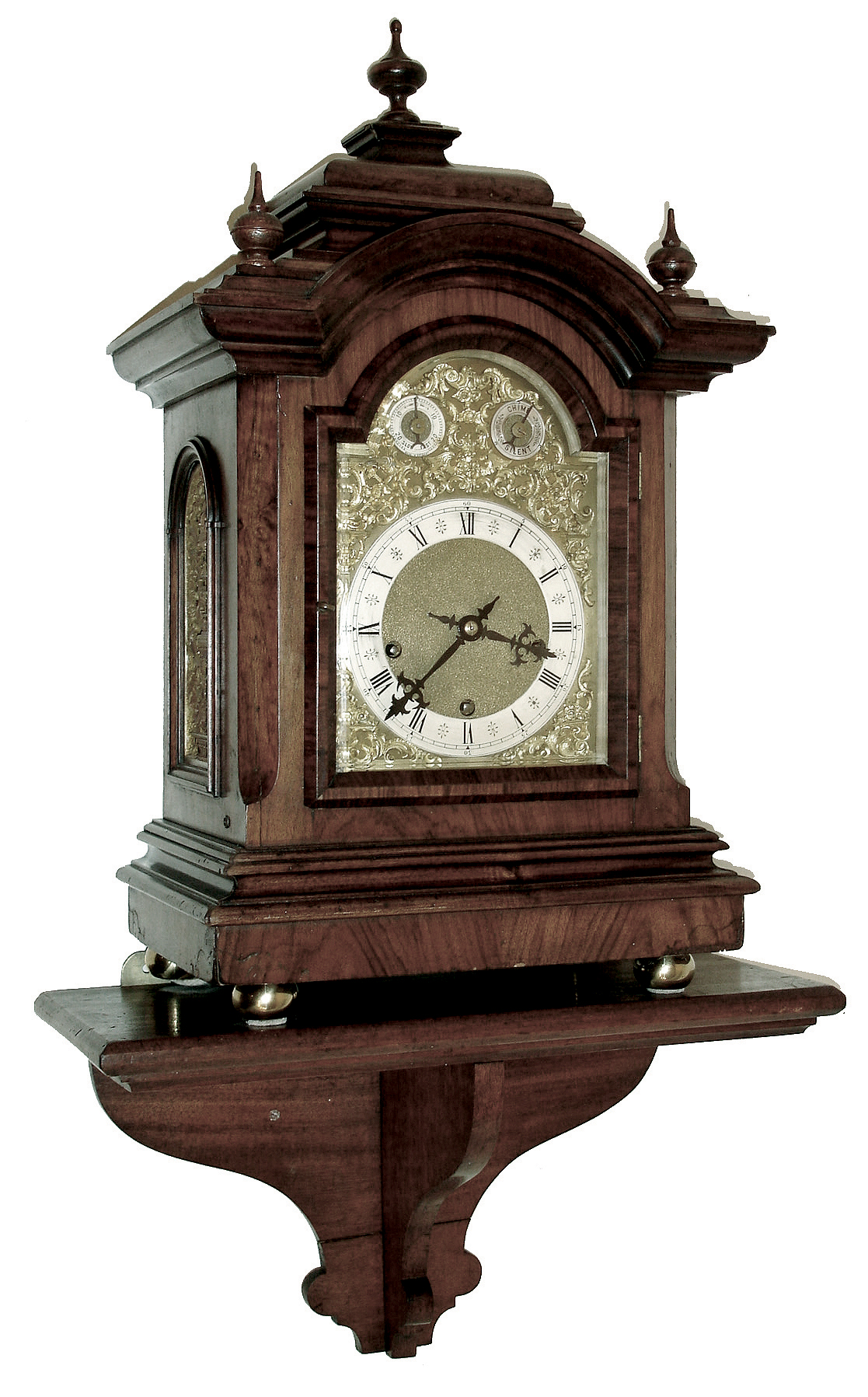 Germany, bracket clock with shelf, walnut and walnut veneer case with heavily molded top and base, composite dial with gilt spandrels, and Roman numeral silvered chapter ring, fancy blued steel hands, sides with cast frets with rococo style ornament, 8 days, three train movement sounding Westminster chimes on gongs, and counting the hours on a large gong, c1900 — Antique Clocks Price Guide
