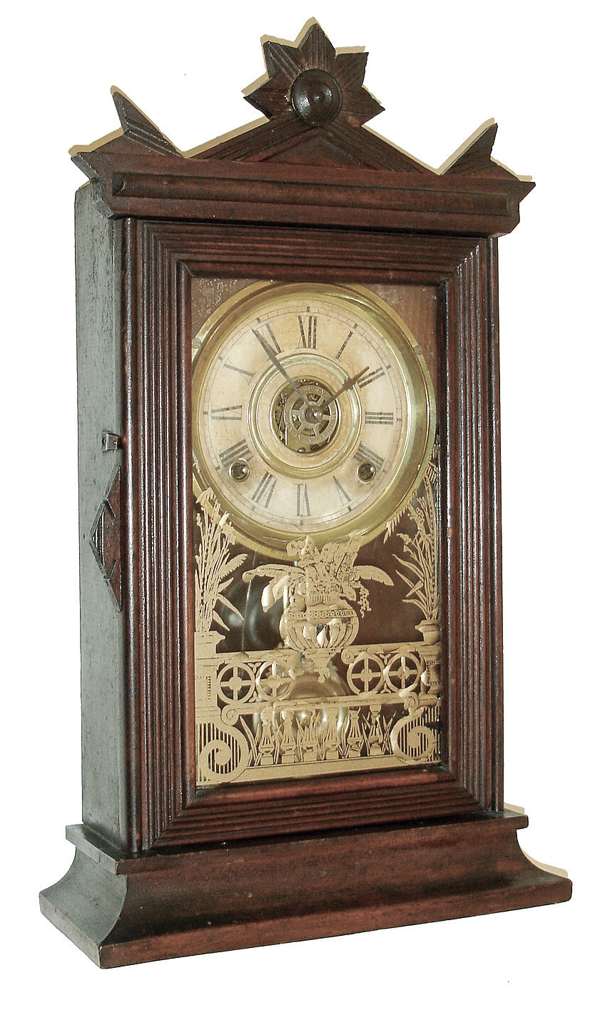 Clocks- 3 (Two) American: (1) E. Ingraham & Co., Bristol, Conn., ÓAcmeÒ shelf clock in a walnut case with a spring driven, 8 days, time, strike and alarm movement, c1882; (2) Seth ThomasÕ Sons & Co., New York, No. 5001 model time and bell strike candle stand clock, less dome (3) Ansonia Clock Co., Ansonia, Conn., ÓCoralÒ, 8 days, time and strike, spring brass movement crystal regulator mantel clock, c1914 — Antique Clocks Price Guide