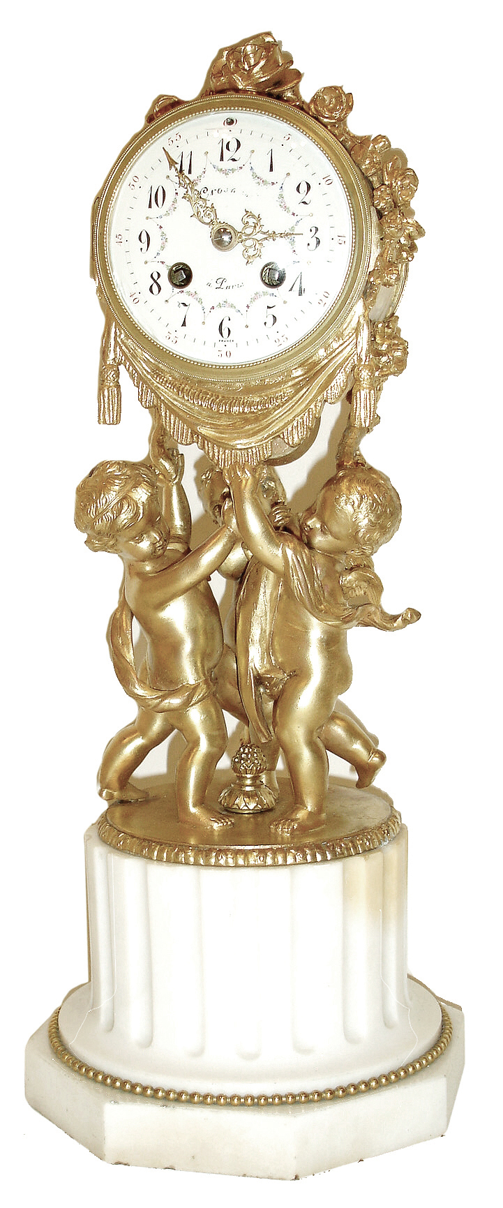 Samuel Marti, Paris, France, mantel clock, three gilt putti supporting the drum form case, the top draped with a garland of roses, gilt bezel with convex glass, Arabic numeral white enamel dial with polychrome enamel floral festoons, fancy gilt hands, all resting on a white marble fluted plinth with octagonal base, 8 days, time and strike, pendule a Paris movement, c1900 — Antique Clocks Price Guide