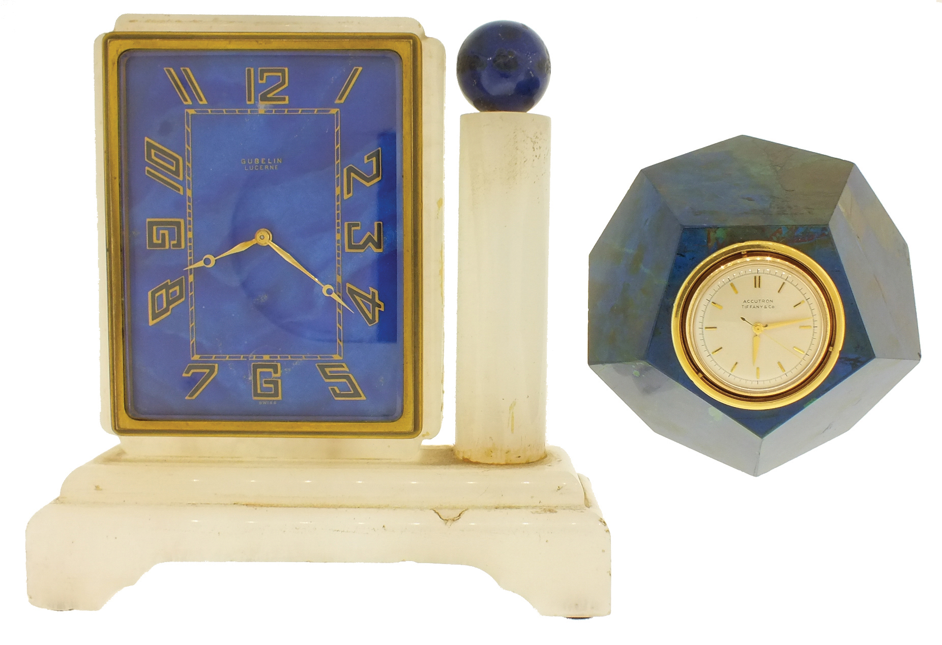 Clocks- 2 (Two): An Art Deco style desk clock with alabaster case and lapis lazuli dial marked ÓGubelin LucerneÒ, and a trapezohedronal confusionite (possibly also lapis), paperweight clock mounted with an 18 karat yellow gold Accutron calibre 214 timepiece, the dial and case signed Tiffany & Co. — Antique Clocks Price Guide