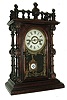 Welch, Spring & Co., Forestville, Conn., GERSTER, V.P., from the Patti series. This is one of two of the Gerster model that we are offering in this sale, in addition to a Patti. The case is of rosewood, with turned corner columns & decorative buttons. Typical polished red brass pendulum with glass center, c1885