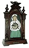 Japan, ÓAÒ on dial, probably Aichi of Nagoya, BLINKING EYE parlor clock, with typical open spring movement, this one with lever escapement, the balance showing on the dial, and with a hidden connection from the lever to the eyes that produces animation. The case of Germanic influence, with embossed brass caryatids and buttons, and surmounted by a spread wing bird, c1905