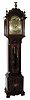 John Elliott, London, England for Bigelow, Kennard & Co., Boston, Mass., tall clock, time, strike and Westminster chime on cathedral gongs, 8 days, three brass, weight driven movement in a mahogany inlaid case with floral motif on door and urn with flowers on base, both framed with herring bone inlay, Roxbury fretwork and brass capped full Corinthian columns on hood, three upper brass finials including center eagle finial, trunk door surmounted by clamshell carving and flanked by fluted quarter columns with brass caps and bases, all resting on a cutout skirt with ogee bracket feet. The brass dial has ornately cutout and engraved brass corner spandrels and profusely engraved dial center silvered chapter ring with applied brass numerals, hour strike / silent and Westminster chime / silent selectors and moon phase dial, c1910