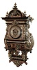 Lenzkirch, Germany, a very rare ÒFreischwingerÓ of oak and brass, with ebonized trim; large and impressive with cast and polished finials. There are full form winged maidens flanking the dial, and several cast faces of Northwind, Minerva and Diana, and the case sides with large swirls of cast brass. A very heavy item, Serial No. 427222, c1869