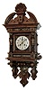 Lenzkirch, Germany, rare Freischwinger in walnut, similar to the model 70, but with different side columns and with cast brass adornments; note the tops of the Corinthian columns are brass as well; this is a desirable quarter striking clock, and with fancy cast ÒcupidÓ pendulum. There are 4 variations on this clock in the sale today. Serial Nr. 1,133,599, c1897