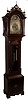 J.J. Elliott, 5 Percival St., London, England, tall case clock, 8 days, time, strike, with calendar and chimes on eight bells and five gongs. Three brass, weight driven movement in a inlaid mahogany case with fluted corner columns with brass capitals. Fretwork crest with three brass finials, inlaid herring bone, fan and urn elements. The brass dial has a silvered chapter ring, engraved and pierced brass spandrels and elaborate dial center, moon phase, subsidiary seconds, strike / silent and tune selectors for Whittington & Westminster, c1915