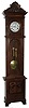 Lenzkirch, Germany, tall case clock, 8 days, time and bell strike, two brass, weight driven movement in a walnut case with an ornately carved top, applied carvings to base, cartouches on either side of door and white enamel dial, serial number 474673, c1879