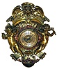 Lenzkirch, Germany, heavy bronze figural wall clock, 8 days, time and strike, spring driven movement in a multicolor brass and bronze case with Putti flanking the silvered brass dial with cast dial center, one holding a torch and flowers and the other holding an owl. A female angel gazing downward at Putti surmounts the clock. The well made movement is series number 52 bearing the Lenzkirch logo and serial number 458795, c1878 includes an original Lenzkirch key