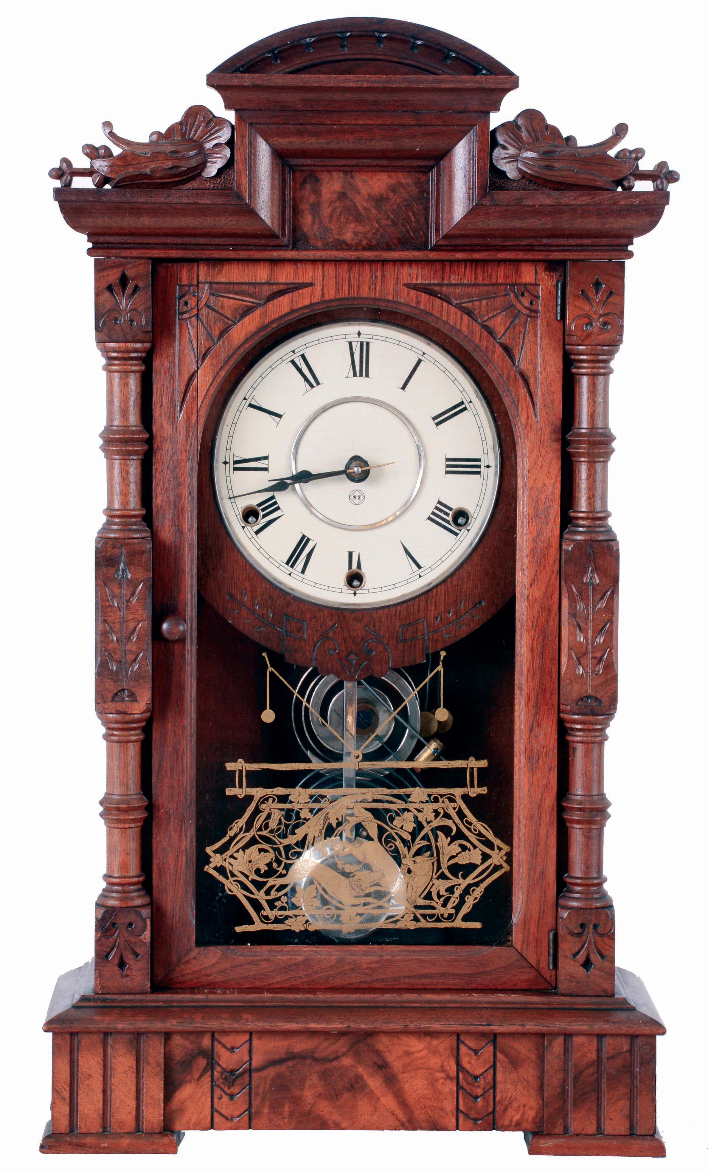 Seth Thomas Clock Co., Thomaston, Conn., "Hecla" mantel clock in a walnut case with a three train, 8 days, spring driven movement, striking the quarter hours on 2 cup bells and the hours on a cathedral bell, c1884. — Antique Clocks Price Guide