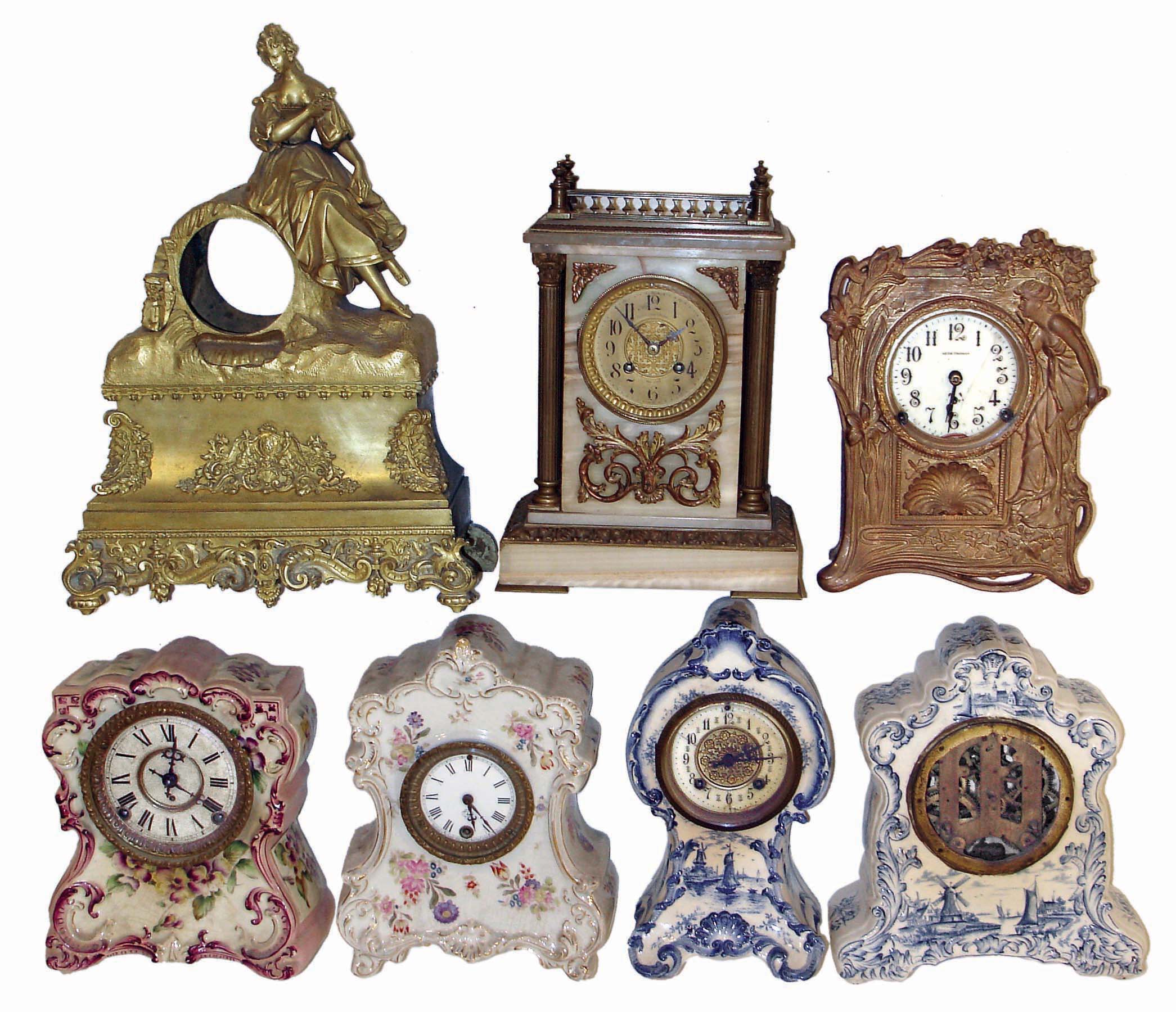 Clocks & Statues- 21 (Twenty-one): 4 cast metal seated figures; 1 French gilt metal case (no movement); 4 American porcelain case; 1 onyx French sold by Camerden & Forester, New York; Seth Thomas Art Nouveau metal case; 1 400 day; French marble with balance wheel Duverdrey & Bloquel movement; 6 small celluloid desk clocks; 1 United movement with animated dial; French alabaster and gilt metal figural; late 19th and early 20th centuries — Antique Clocks Price Guide
