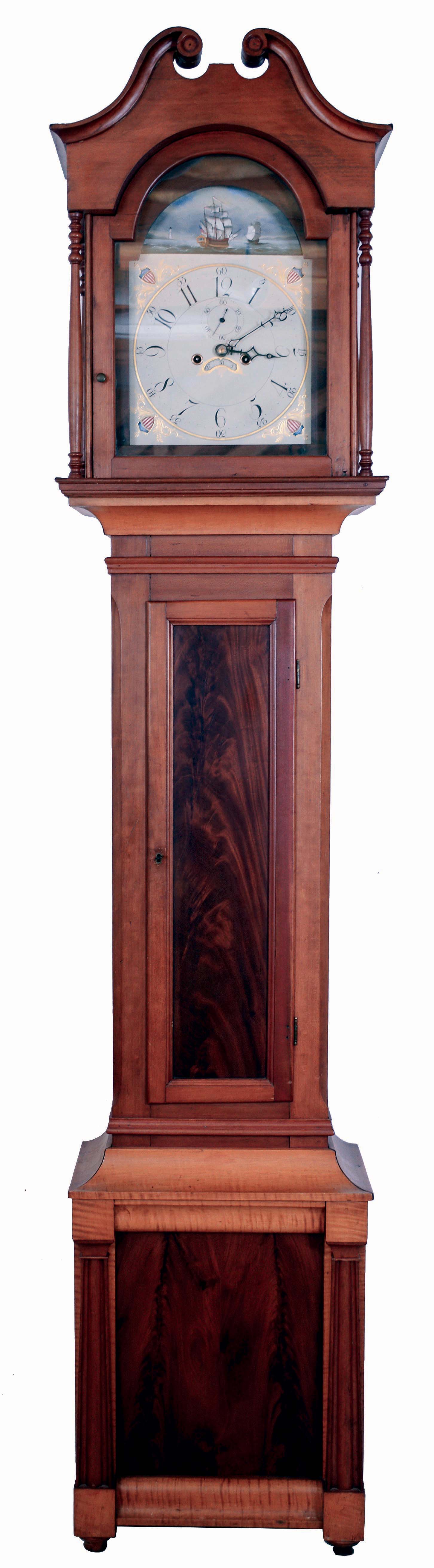 Pennsylvania tall clock, 8 days, time and strike, weight driven movement in a mixed wood case, cherry, tiger maple and crotch mahogany panels in base plinth and trunk, with broken arch, four full columns flanking hood on turned feet. The painted iron dial has date calendar and second's bit, c1825 — Antique Clocks Price Guide