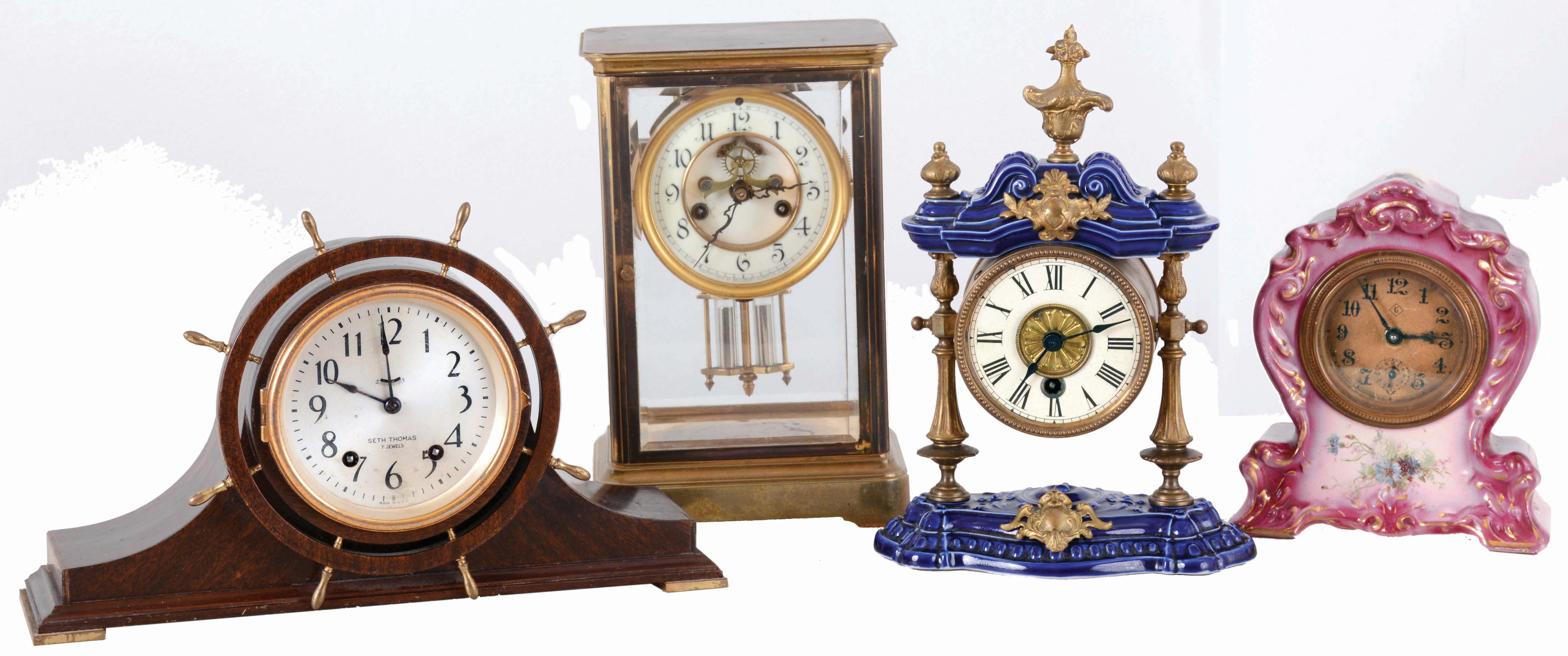 Clocks- 4 (Four): (1) Waterbury Clock Co., "Granville" crystal regulator, c1913; (2) Seth Thomas wood mantel, c1935; (3) William L. Gilbert "Hub", 30 hours, backwind porcelain; (4) Junghans, 30 hours, porcelain timepiece, c1910. — Antique Clocks Price Guide