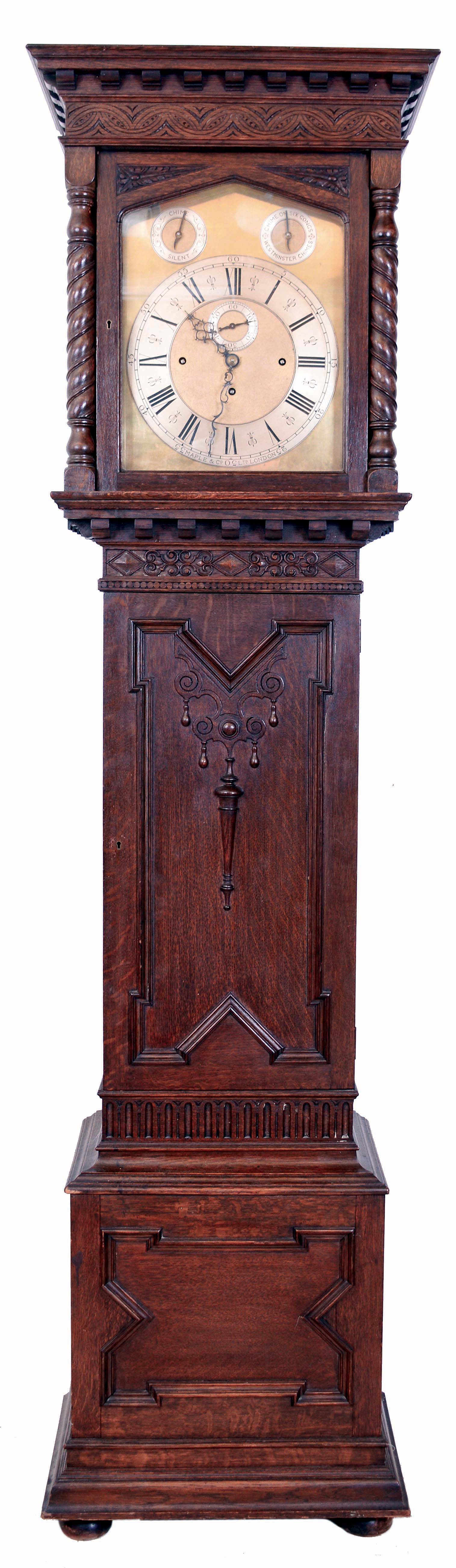 Maple & Co., Ltd., London, England, tall clock, 8 days, time, strike and chime, playing Westminster or tune on 6 gongs, three brass weight driven unsigned Elliot movement in a carved oak case on bun feet with rope twist columns flanking hood. Brass dial with silvered chapter ring, second's bit, strike / silent and tune selectors, c1910 — Antique Clocks Price Guide