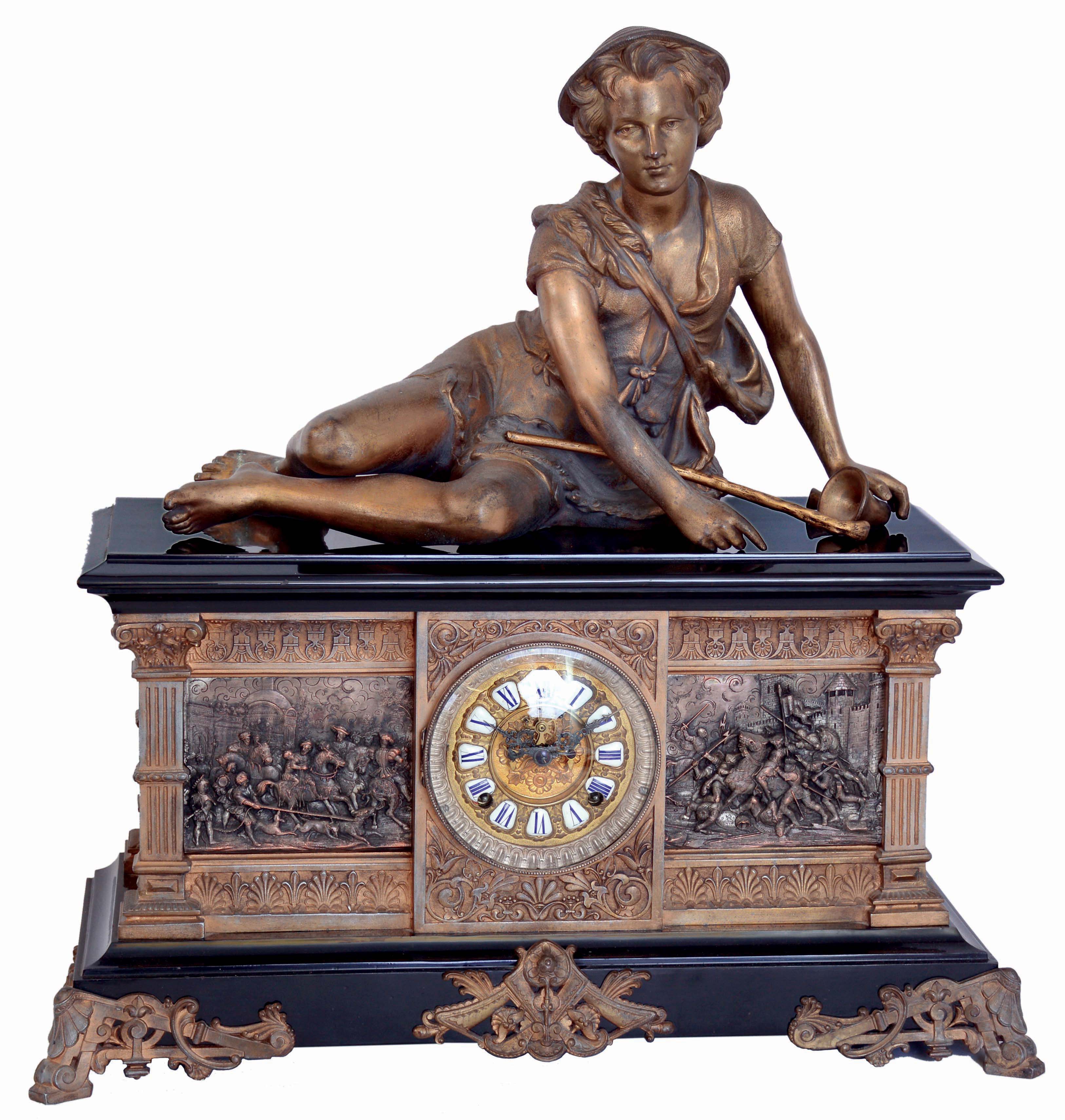 Ansonia Clock Co., New York, NY, "Columbia" figural shelf clock, 8 days, time and strike, spring driven movement in a enameled cast iron case with applied cast friezes depicting Medieval military scenes, resting on large cast brass front feet surmounted by a spelter statue of shepherd boy reclining, and a extra fancy cast brass dial with applied Roman numerals and open escapement, c1890 — Antique Clocks Price Guide