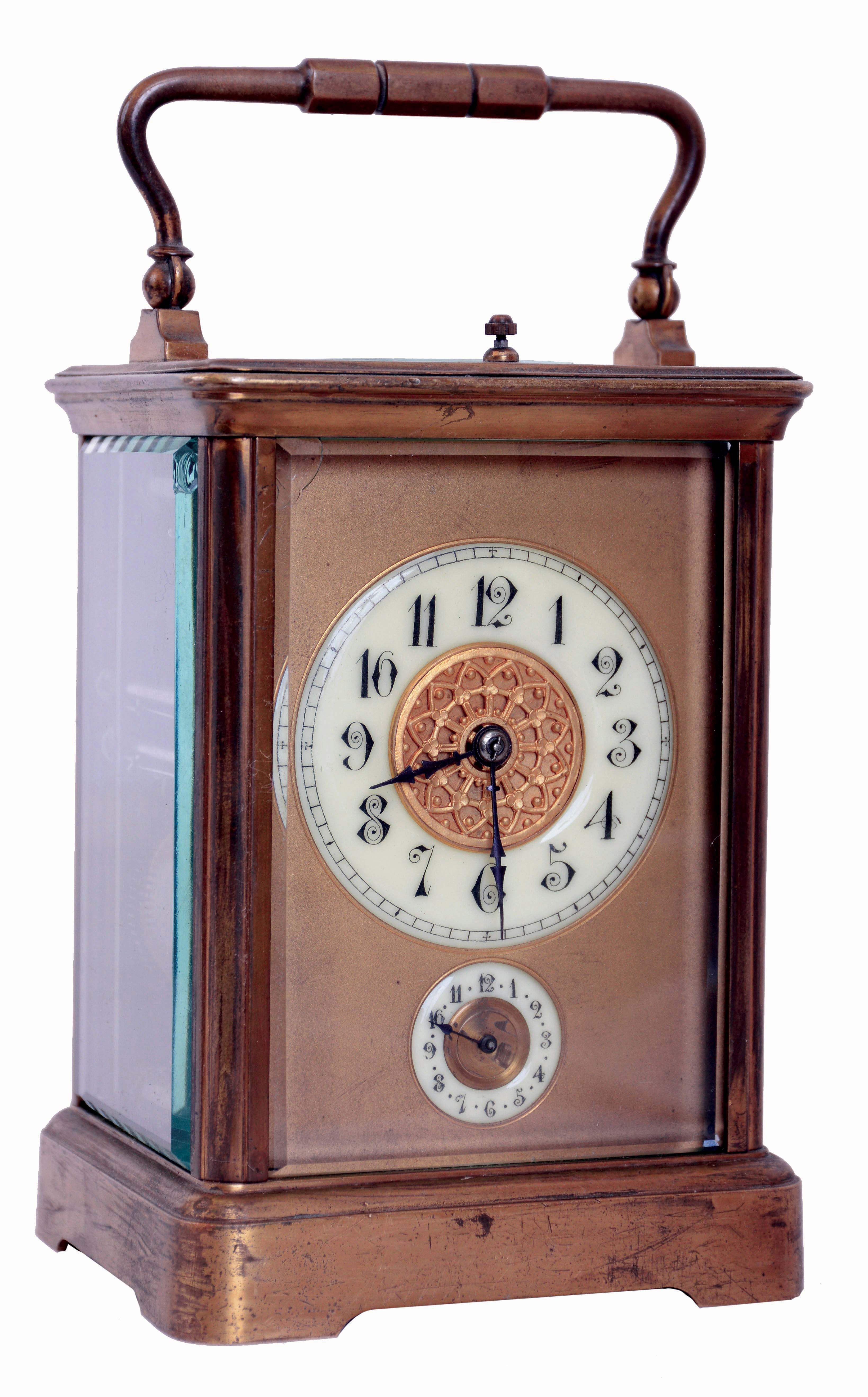 France, repeating carriage clock with alarm, gilt Corniche case with bevelled glasses, Arabic numeral white enamel dials with matted gilt mask, blued steel hands, 8 days, time, strike, and alarm movement with lever platform, petit sonnerie quarters, and grand sonnerie repeating, with sonnerie/ silent lever in base, c1900 — Antique Clocks Price Guide