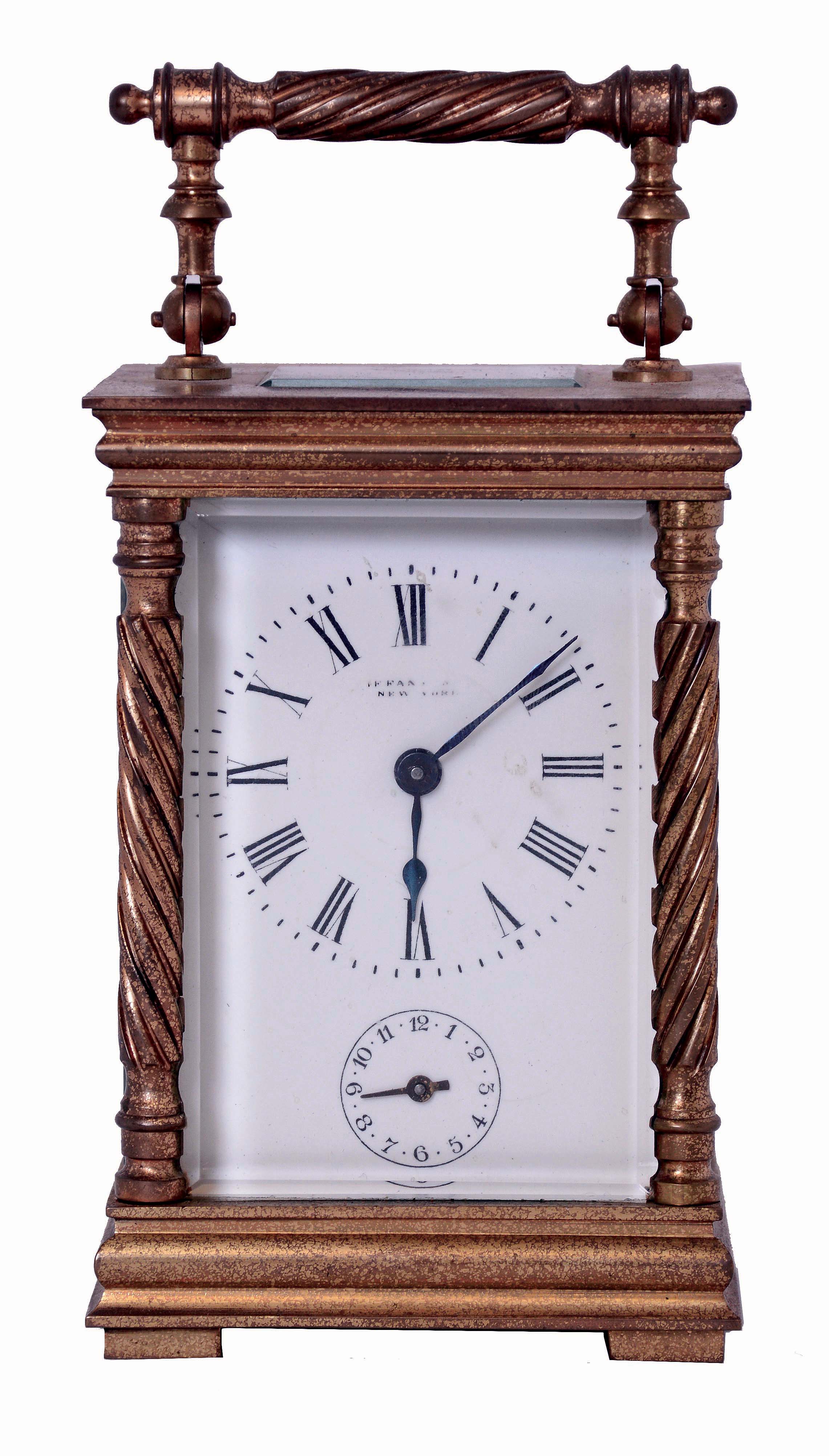 France, for Tiffany & Co., carriage clock in a glazed, gilt brass case, with twist turned columns and handle, Roman numeral white enamel dial, blued steel hands, 8 days, time and alarm movement with lever platform, c1900, together with a leather covered outer case from a larger clock — Antique Clocks Price Guide