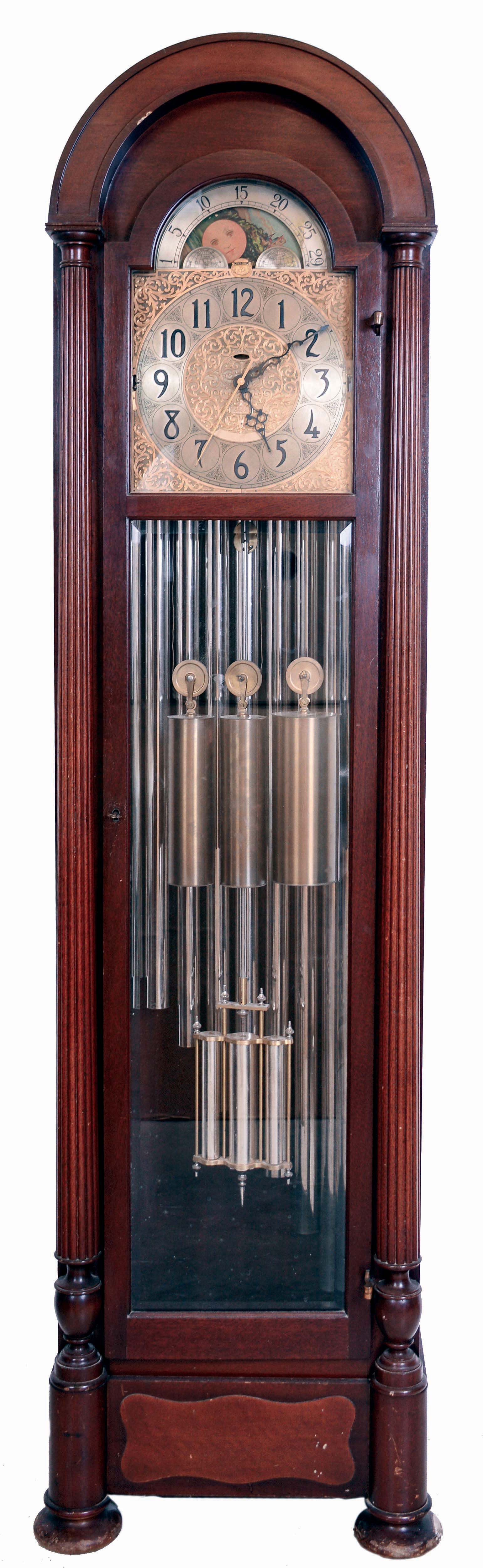 Revere Clock, Co., Cincinnati Ohio, (division of Herschede), "Hamilton" 9 tube tall clock playing three tunes, Westminster, Whittington and Canterbury with Telechron electric movement in a dome top mahogany case with beveled glass sides and trunk door, full length full reeded columns on bun feet. The brass dial has moon phase and silvered chapter ring with applied black numerals and spandrels, c1934 — Antique Clocks Price Guide