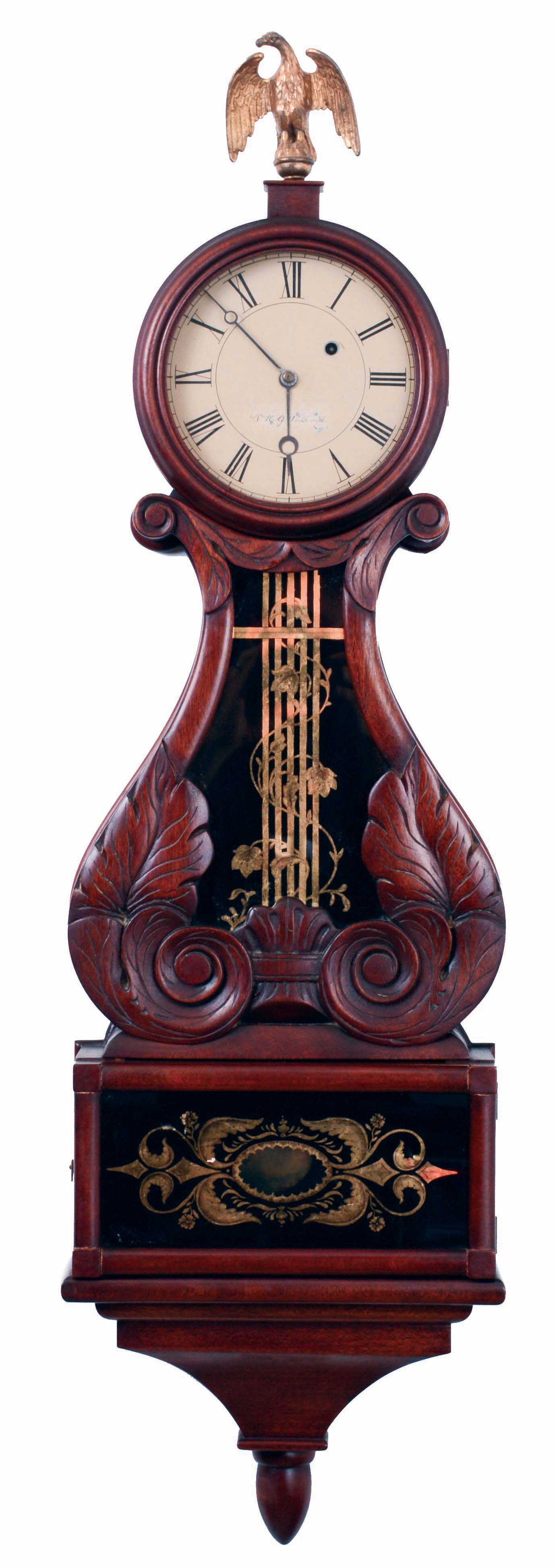 Victor Wadlund, reproduction lyre clock. Mahogany case with leaf and scroll carved throat panel, eagle finial, tablets with gilt ornament on a black painted ground, Roman numeral white painted sheet metal dial, 8 days, weight driven timepiece movement, dated 1952. — Antique Clocks Price Guide