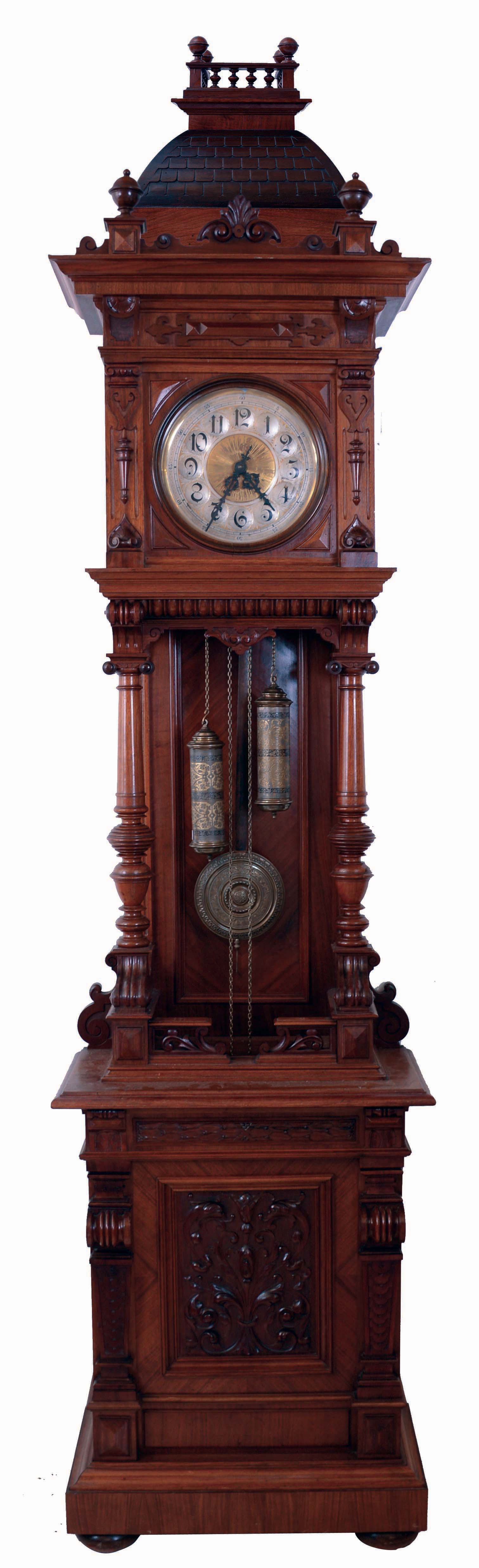 RSM, Germany, open well tall clock, 8 days, time and strike, brass weight driven movement in a well carved walnut case with columns supporting hood, bun feet, matching pendulum and weight decoration, silvered brass dial, c1910 — Antique Clocks Price Guide